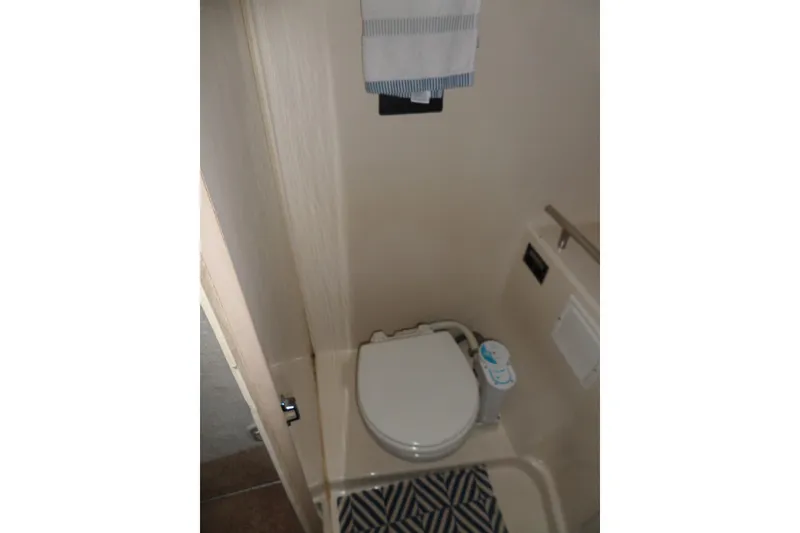 Slide: The Image of Bathroom interior of 2000 Bayliner 3055 Ciera boat with toilet and towel. - 50