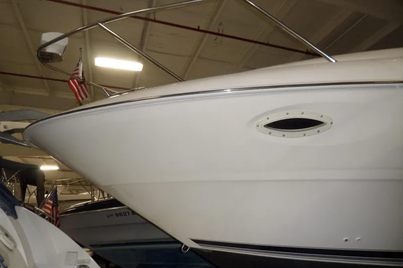 Slide: The Image of 2000 Bayliner 3055 Ciera boat in indoor storage, featuring sleek white hull design. - 55
