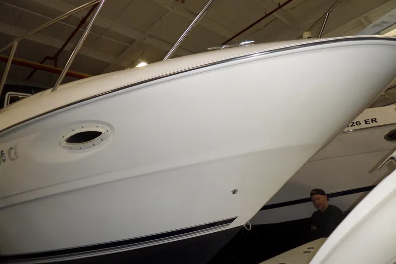 Slide: The Image of 2000 Bayliner 3055 Ciera boat in indoor storage, showcasing sleek hull design. - 56
