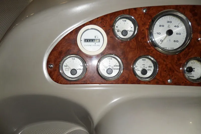 Slide: The Image of Dashboard of a 2000 Bayliner 3055 Ciera with various gauges and wood paneling. - 6