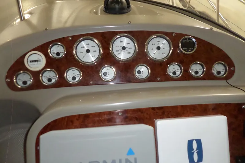 Slide: The Image of Dashboard of a 2000 Bayliner 3055 Ciera boat with multiple gauges and controls. - 7