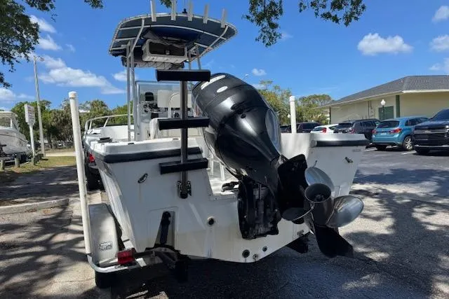 Slide: The Image of 1999 Mako 221 Center Console boat with outboard motor in a parking lot. - 2