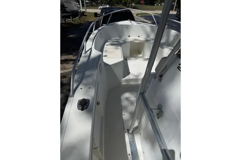 Slide: The Image of 1999 Mako 221 Center Console boat interior with seating and railings. - 4