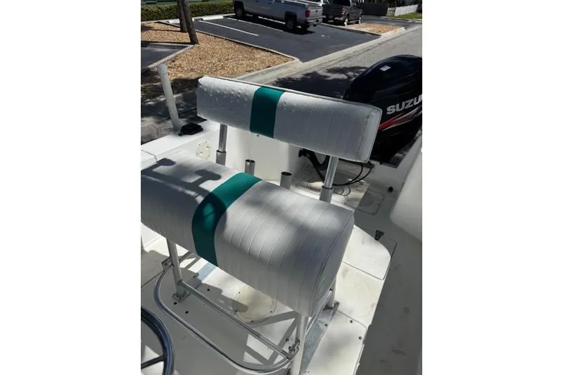 Slide: The Image of 1999 Mako 221 Center Console boat interior with white and teal seating. - 7