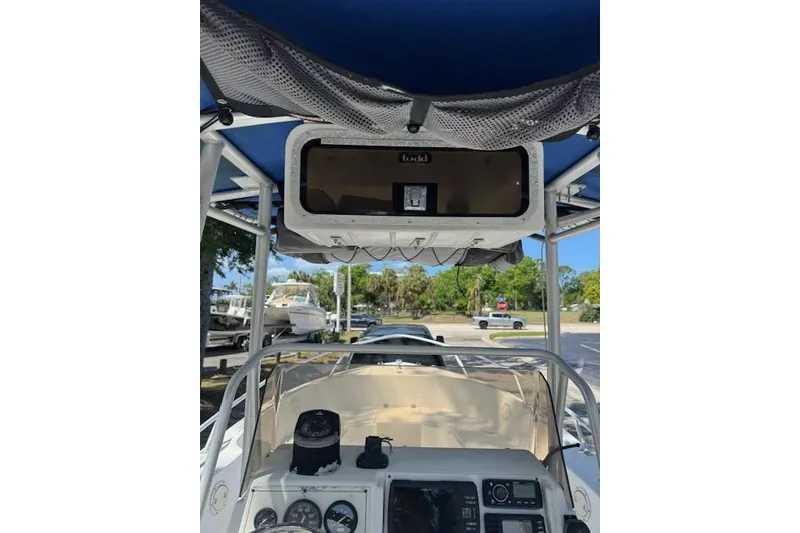 Slide: The Image of 1999 Mako 221 Center Console boat interior with navigation equipment and canopy. - 9