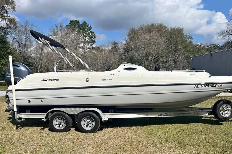 The Image of 2017 Hurricane SunDeck Sport 232 OB boat on trailer, parked outdoors. - 0