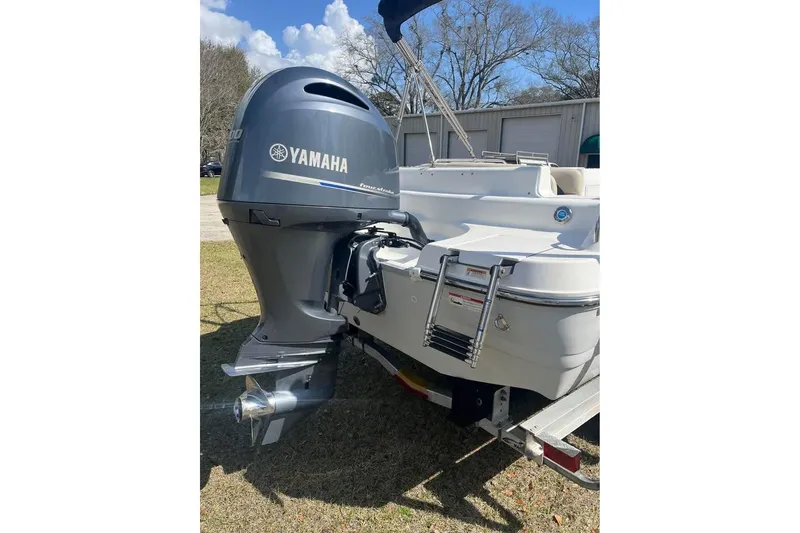 Slide: The Image of 2017 Hurricane SunDeck Sport 232 OB with Yamaha outboard motor, parked on trailer. - 3