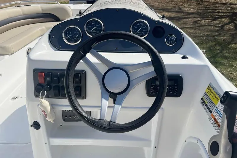 Slide: The Image of Steering console of 2017 Hurricane SunDeck Sport 232 OB boat with gauges and controls. - 5