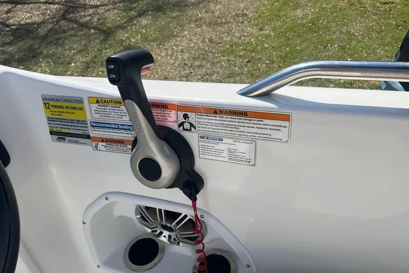 Slide: The Image of Throttle control and warning labels on a 2017 Hurricane SunDeck Sport 232 OB boat. - 6