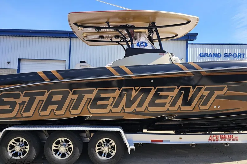 Slide: The Image of 2017 Statement 380 Open boat on trailer, featuring bold branding and sleek design. - 1