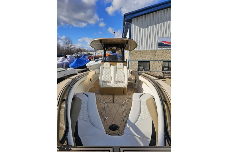 Slide: The Image of 2017 Statement 380 Open boat with luxurious seating and sleek design under a blue sky. - 10