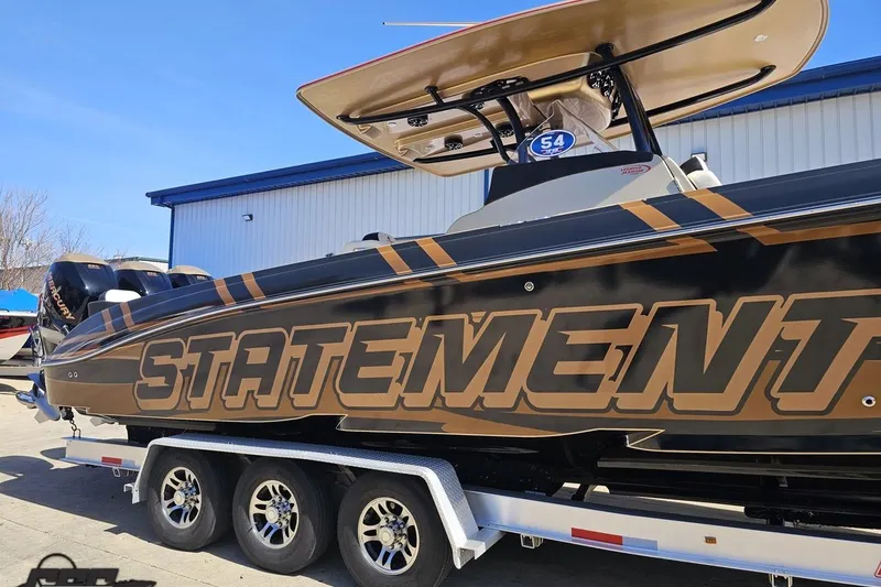 Slide: The Image of 2017 Statement 380 Open boat on trailer, featuring bold branding and sleek design. - 3
