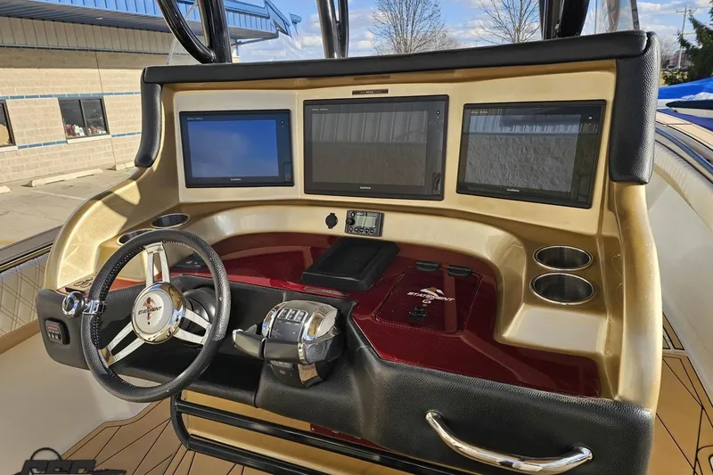 Slide: The Image of Helm of 2017 Statement 380 Open boat with three Garmin displays and steering wheel. - 31