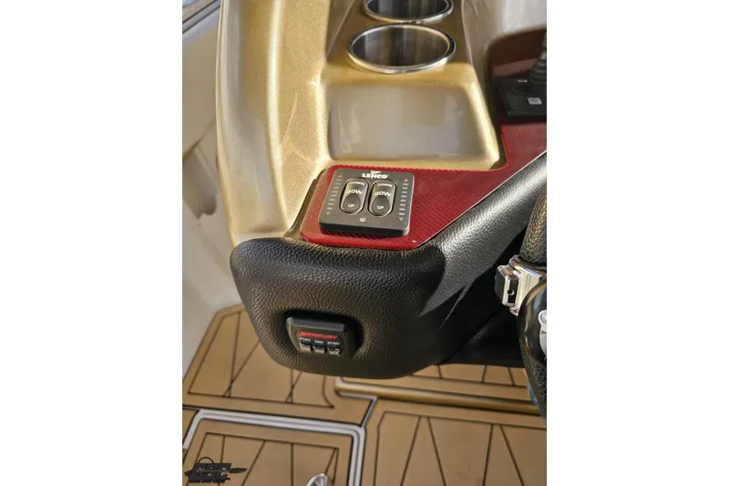 Slide: The Image of Control panel of a 2017 Statement 380 Open boat with cup holders and switches. - 39