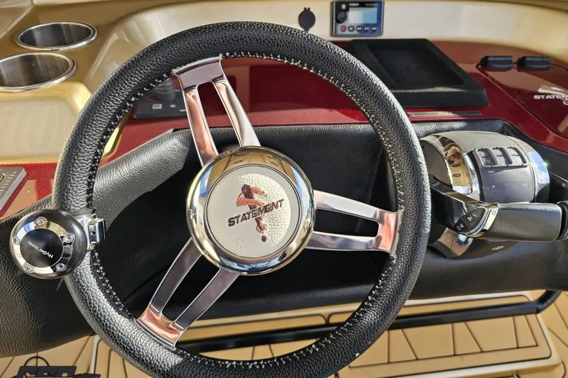 Slide: The Image of Steering wheel and controls of a 2017 Statement 380 Open boat cockpit. - 43