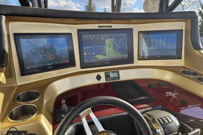 Slide: The Image of Dashboard of 2017 Statement 380 Open boat with three Garmin displays. - 44