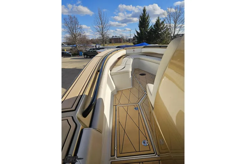 Slide: The Image of 2017 Statement 380 Open boat interior with tan seating and deck, under a blue sky. - 48