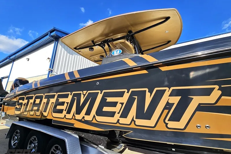 Slide: The Image of 2017 Statement 380 Open boat with bold graphics on a trailer. - 6