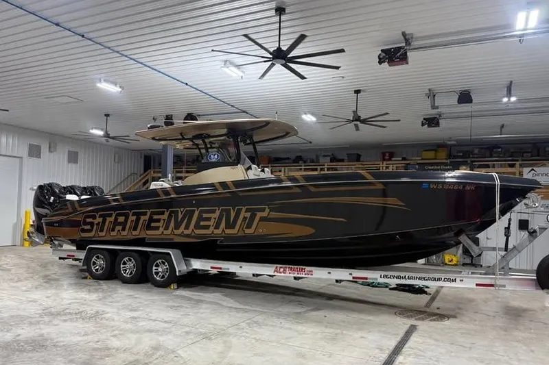 Slide: The Image of 2017 Statement 380 Open boat on trailer in a spacious indoor garage. - 73