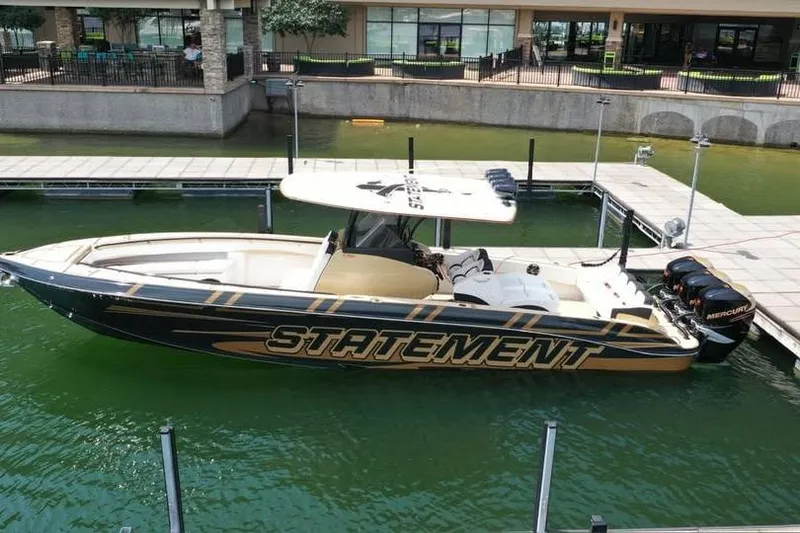 Slide: The Image of 2017 Statement 380 Open boat docked in marina with sleek design and powerful engines. - 74