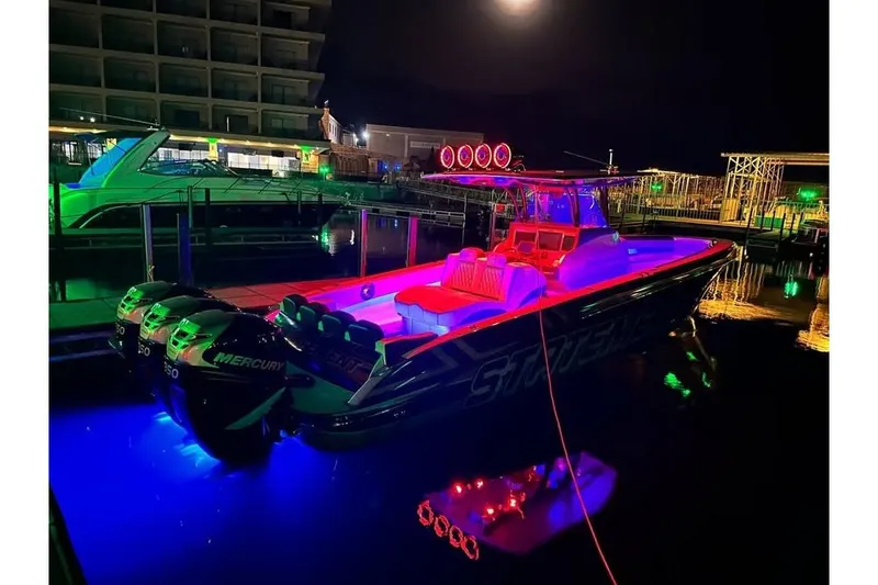 Slide: The Image of 2017 Statement 380 Open boat illuminated with vibrant neon lights at night. - 75