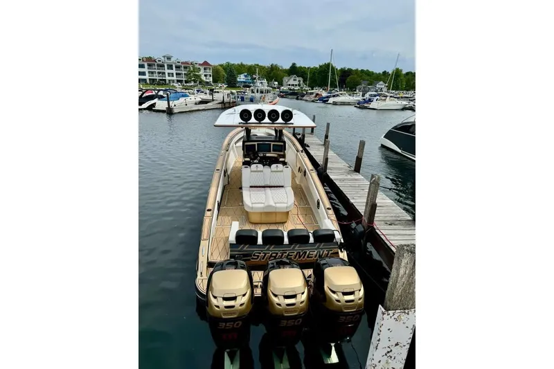 Slide: The Image of Luxury 2017 Statement 380 Open boat docked with triple 350 engines in a marina. - 78