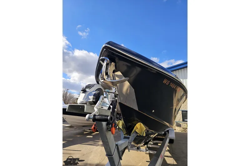 Slide: The Image of 2017 Statement 380 Open boat on trailer under blue sky. - 8