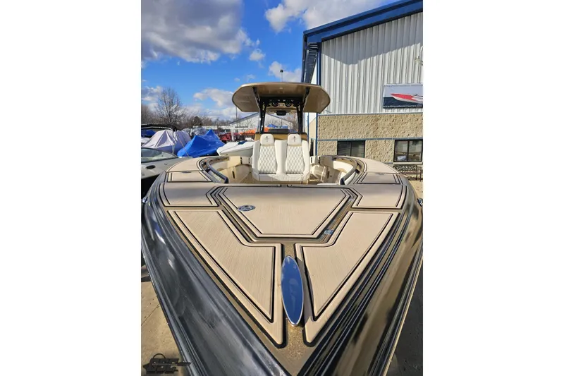 Slide: The Image of 2017 Statement 380 Open boat with sleek design, docked outdoors under blue sky. - 9