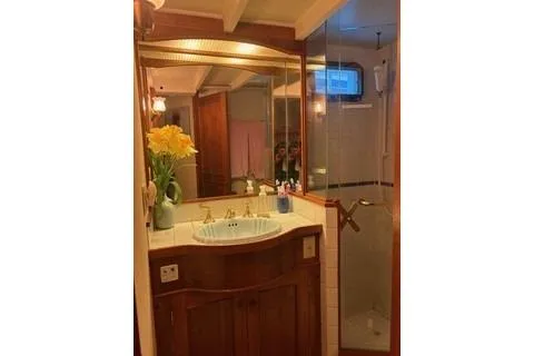 Slide: The Image of 1971 Philbrooks Trawler bathroom with wooden cabinetry, sink, and glass shower. - 10