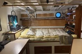 Slide: The Image of Cozy cabin interior of a 1971 Philbrooks Trawler with bed and porthole. - 6