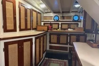 Slide: The Image of 1971 Philbrooks Trawler interior with wooden cabinets and nautical decor. - 7