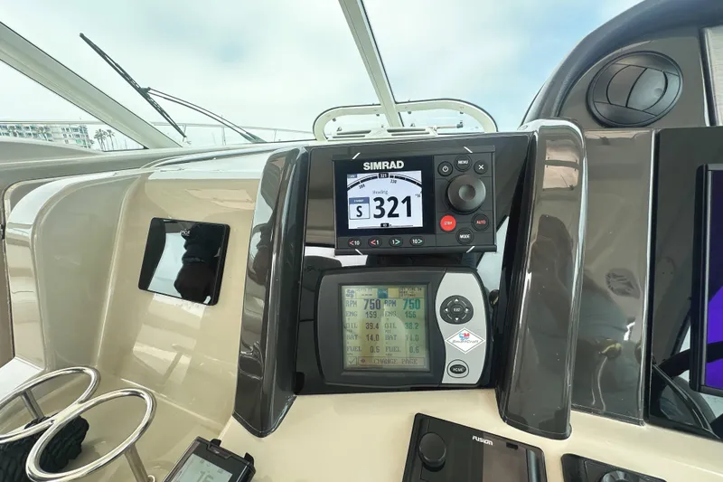 Slide: The Image of Control panel of a 2006 Sea Ray 48 Sundancer yacht with navigation instruments. - 12