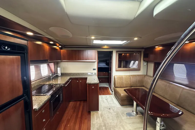 Slide: The Image of Luxurious interior of 2006 Sea Ray 48 Sundancer yacht with kitchen and seating area. - 13