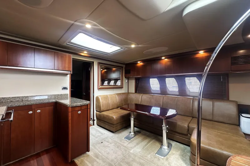 Slide: The Image of Luxurious interior of 2006 Sea Ray 48 Sundancer yacht with elegant seating and modern cabinetry. - 14