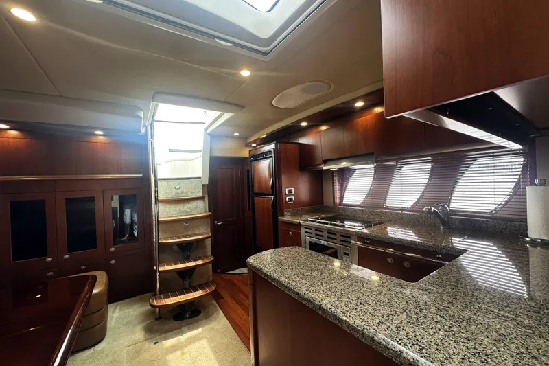 Slide: The Image of Luxurious interior of 2006 Sea Ray 48 Sundancer yacht with modern kitchen and elegant wood finishes. - 16
