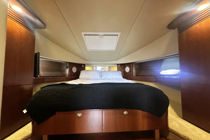 Slide: The Image of Luxurious 2006 Sea Ray 48 Sundancer cabin with cozy bed and elegant wood finishes. - 21