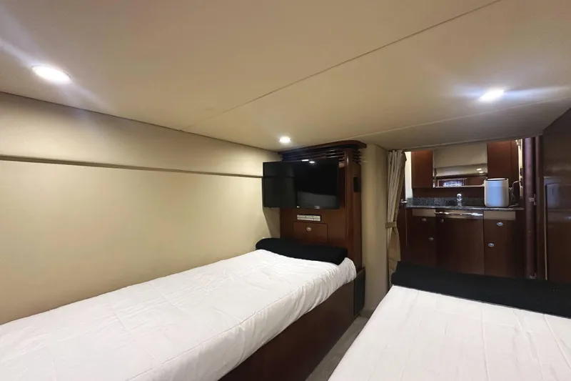 Slide: The Image of Interior of 2006 Sea Ray 48 Sundancer yacht with twin beds and kitchenette. - 24