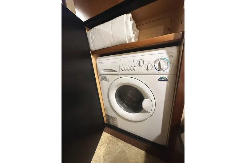Slide: The Image of Washing machine inside 2006 Sea Ray 48 Sundancer yacht, compact and efficient design. - 25