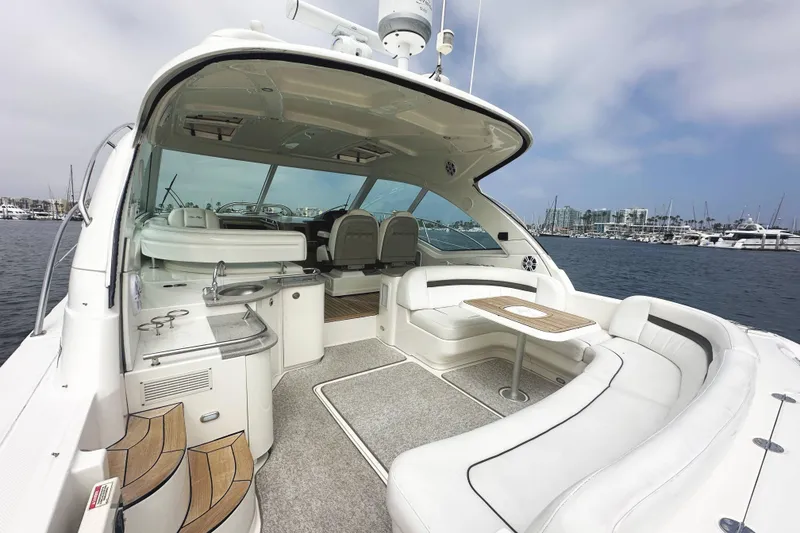 Slide: The Image of 2006 Sea Ray 48 Sundancer yacht with spacious seating and modern amenities in a marina setting. - 4