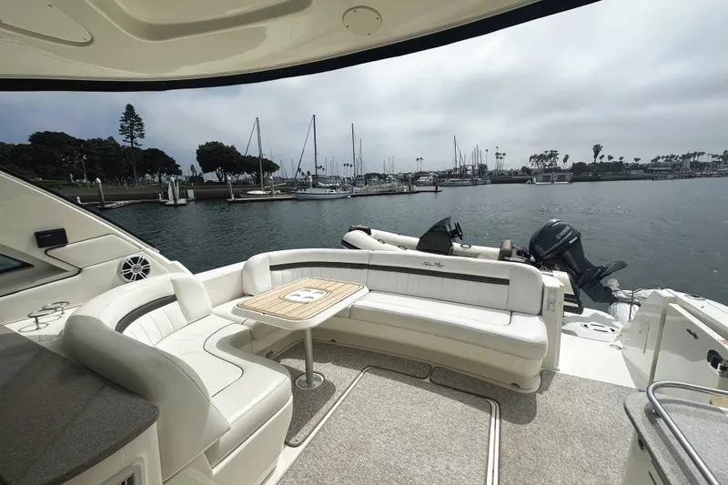 Slide: The Image of Luxurious 2006 Sea Ray 48 Sundancer yacht with elegant seating, docked in a serene marina. - 7