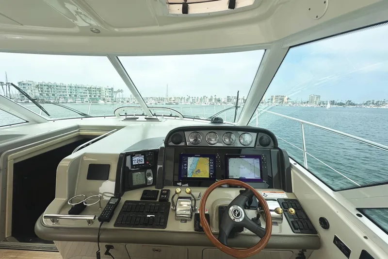 Slide: The Image of Helm of 2006 Sea Ray 48 Sundancer yacht with navigation screens and steering wheel. - 8