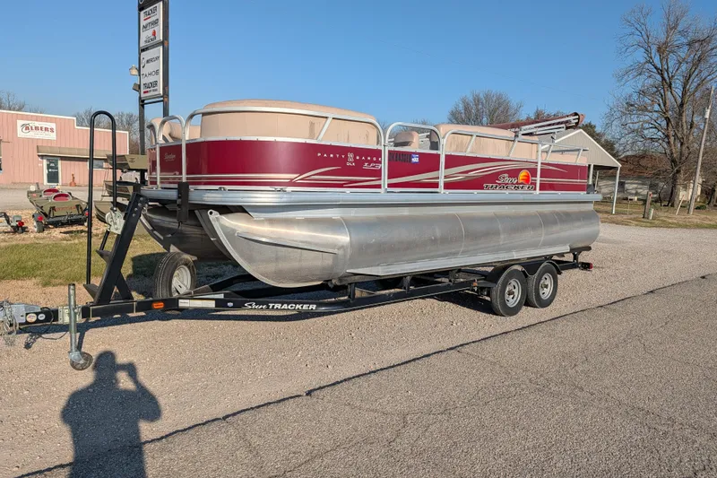 The Image of 2014 Sun Tracker Party Barge 22 XP3 pontoon boat on trailer in outdoor setting. - 28
