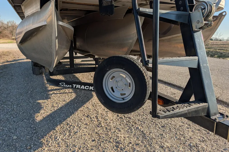 Slide: The Image of 2014 Sun Tracker Party Barge 22 XP3 on trailer, close-up view of pontoon and wheel. - 38