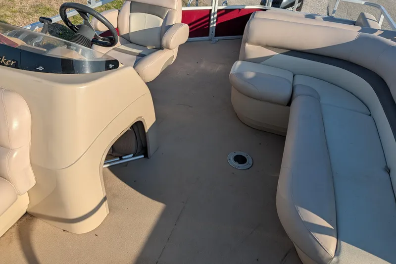 Slide: The Image of 2014 Sun Tracker Party Barge 22 XP3 interior with beige seating and steering console. - 40