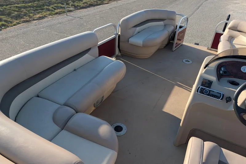 Slide: The Image of 2014 Sun Tracker Party Barge 22 XP3 interior with beige seating and control panel. - 43
