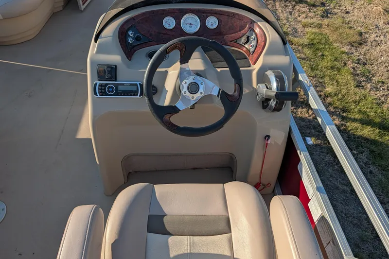 Slide: The Image of 2014 Sun Tracker Party Barge 22 XP3 steering console with gauges and controls. - 44