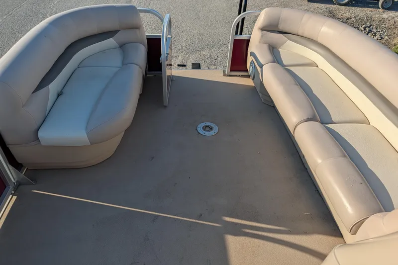 Slide: The Image of 2014 Sun Tracker Party Barge 22 XP3 interior with beige seating and open deck space. - 45