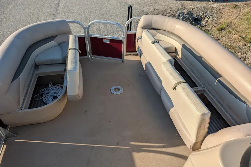 Slide: The Image of 2014 Sun Tracker Party Barge 22 XP3 interior with beige seating and storage compartments. - 46