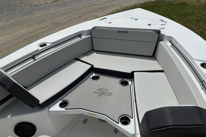 Slide: The Image of 2026 Sea Pro 245FLX Sandbar boat interior with cushioned seating and cup holders. - 10