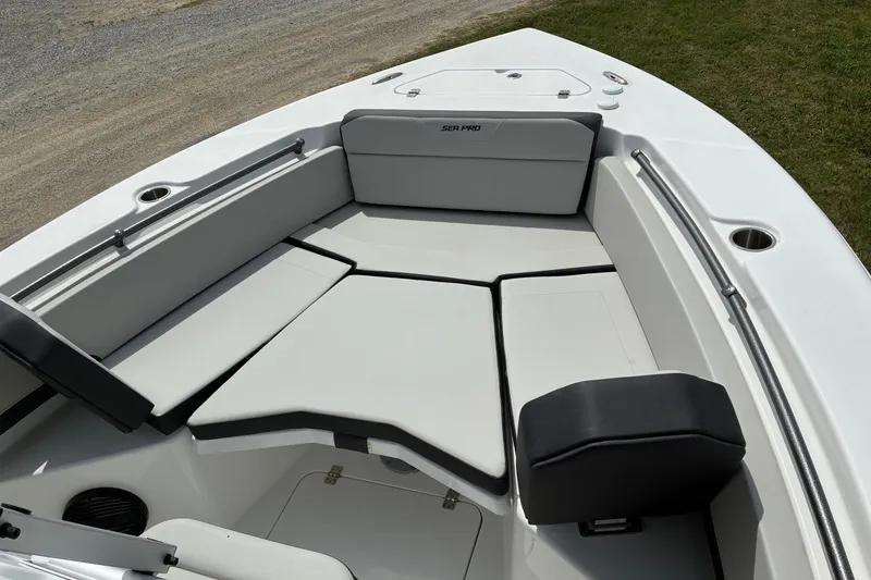 Slide: The Image of 2026 Sea Pro 245FLX Sandbar boat interior with cushioned seating and stainless steel rails. - 11